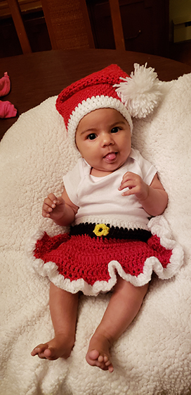 baby girl with crocheted Santa skirt and hat