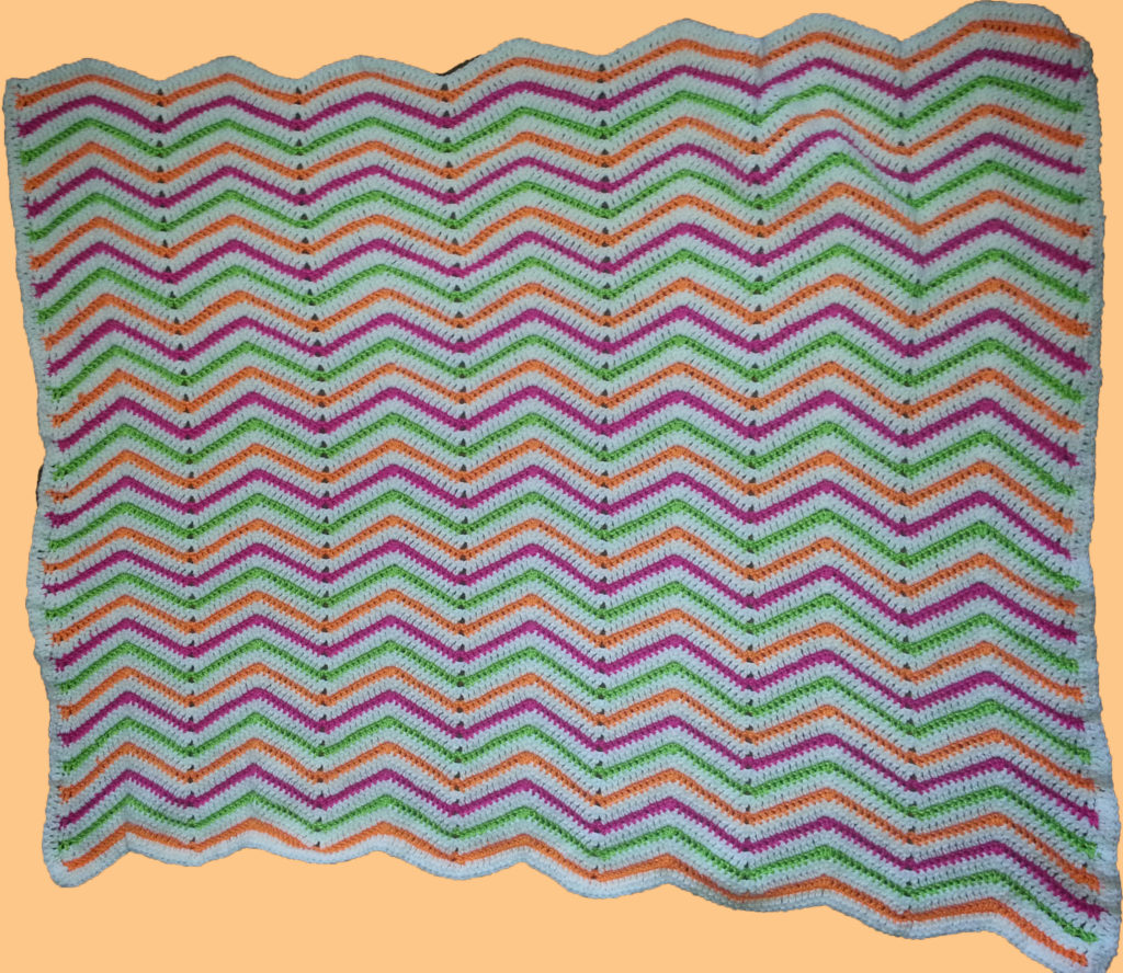 crocheted zig zag pattern bright colored blanket