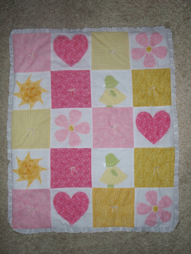 pink, yellow, and white applique quilt for a girl