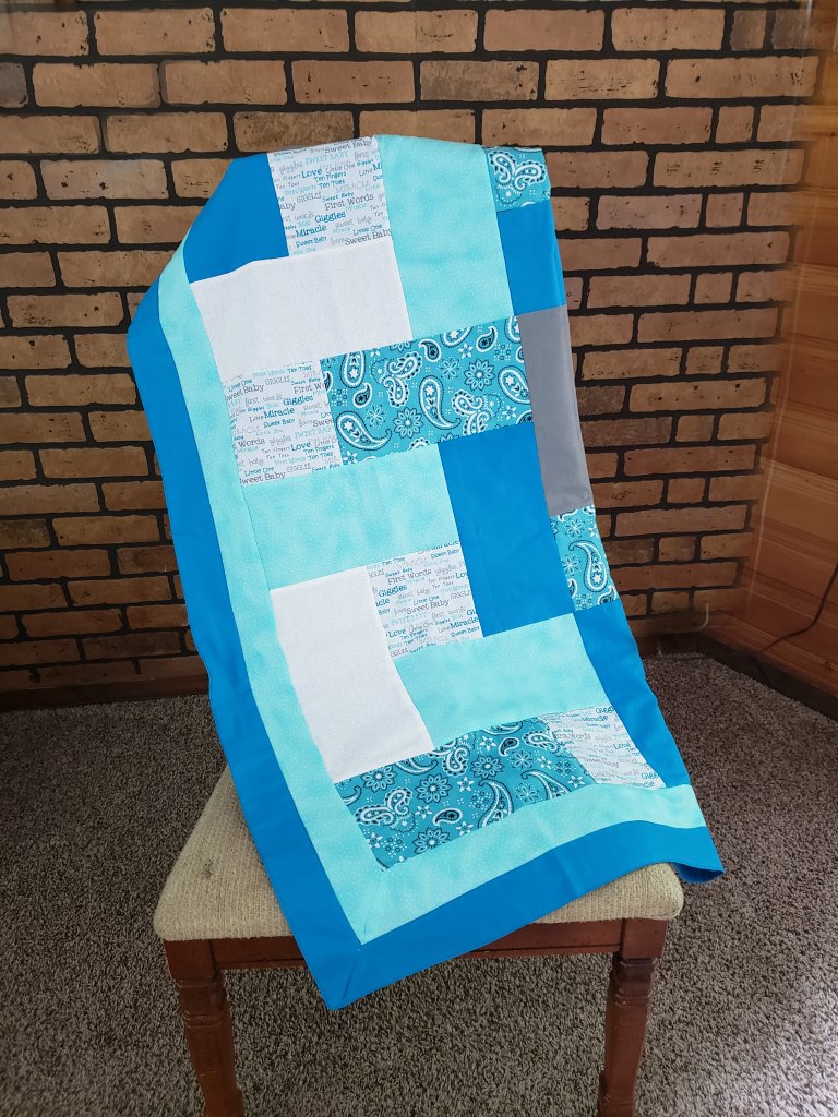 blue, teal, white, and grey block quilt